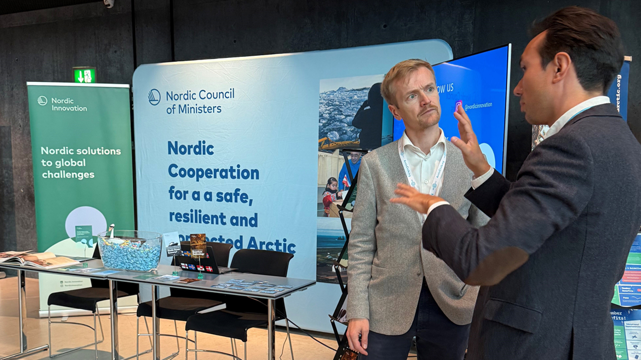 Emil talking to a person attending our stand at Arctic Circle Assembly