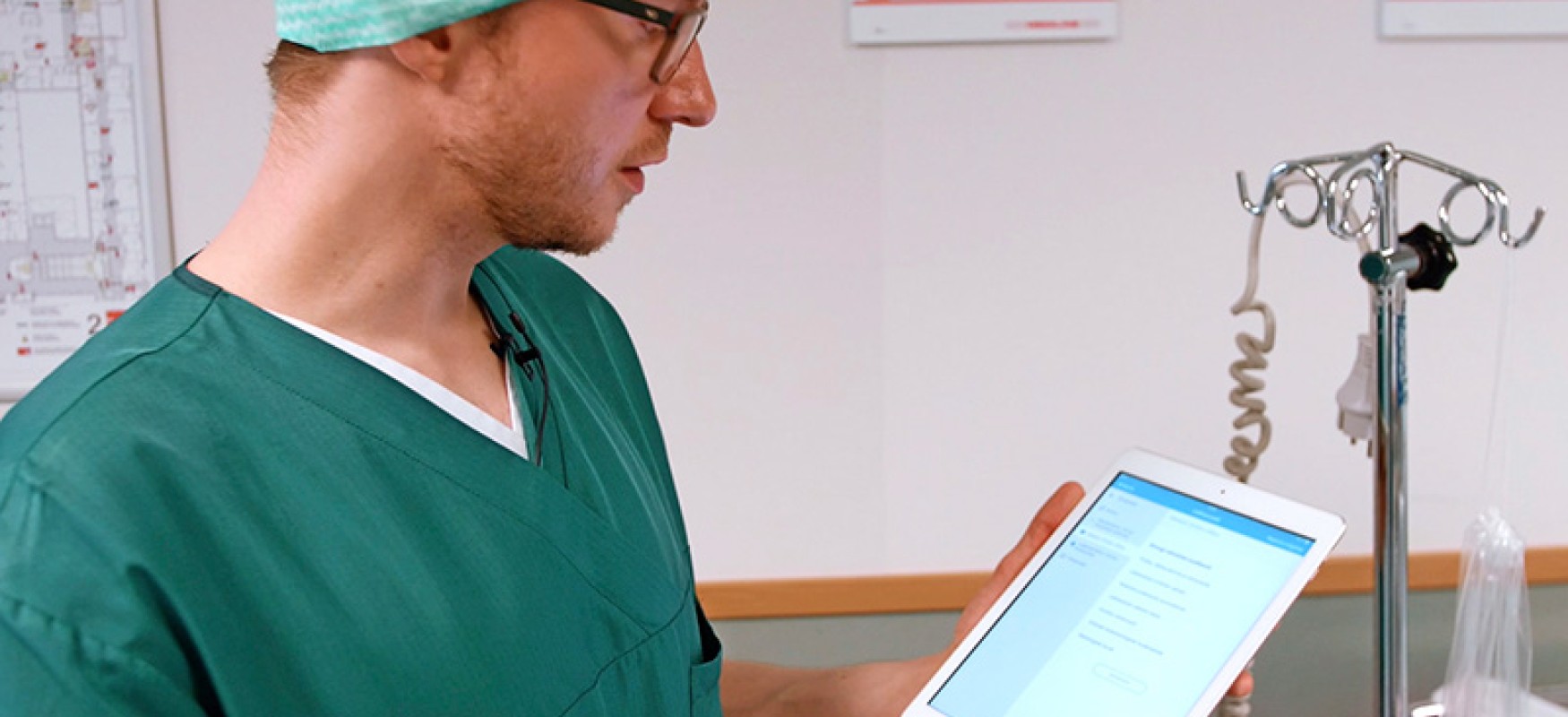 Doctor looking at tablet.