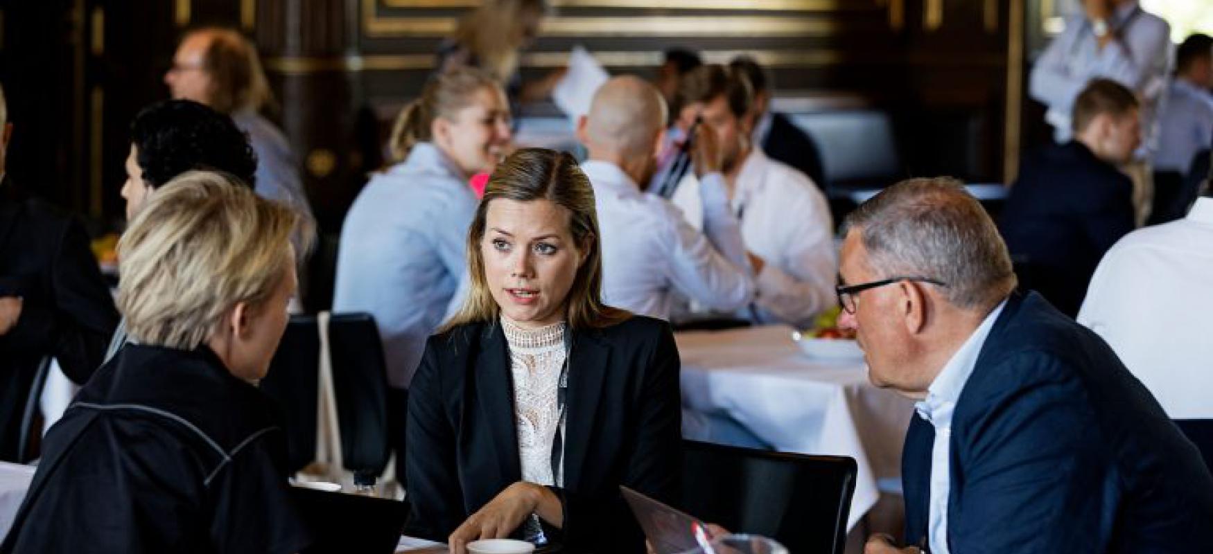 Three people sitting at a roundtable at Nordic Impact Business Summit 2019.