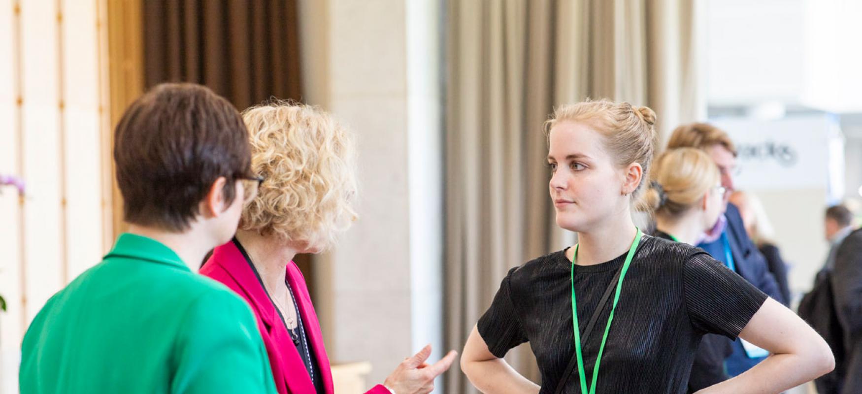 Frigg Harlung-Jensen discussing with colleagues at the WCEF2019