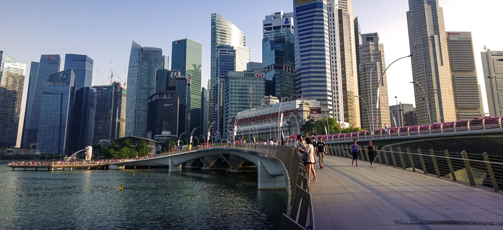 A waterside boardwalk with the Singapore skyline in the background.