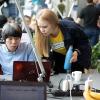 Two people in front of a laptop at a hackathon in Helsinki.