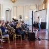 Man speaking in front of a crowd at the Sustainable Urban Solutions 2018 conference.