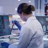 Two scientists in white lab coats in a lab