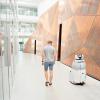 Man walking alongside a robot